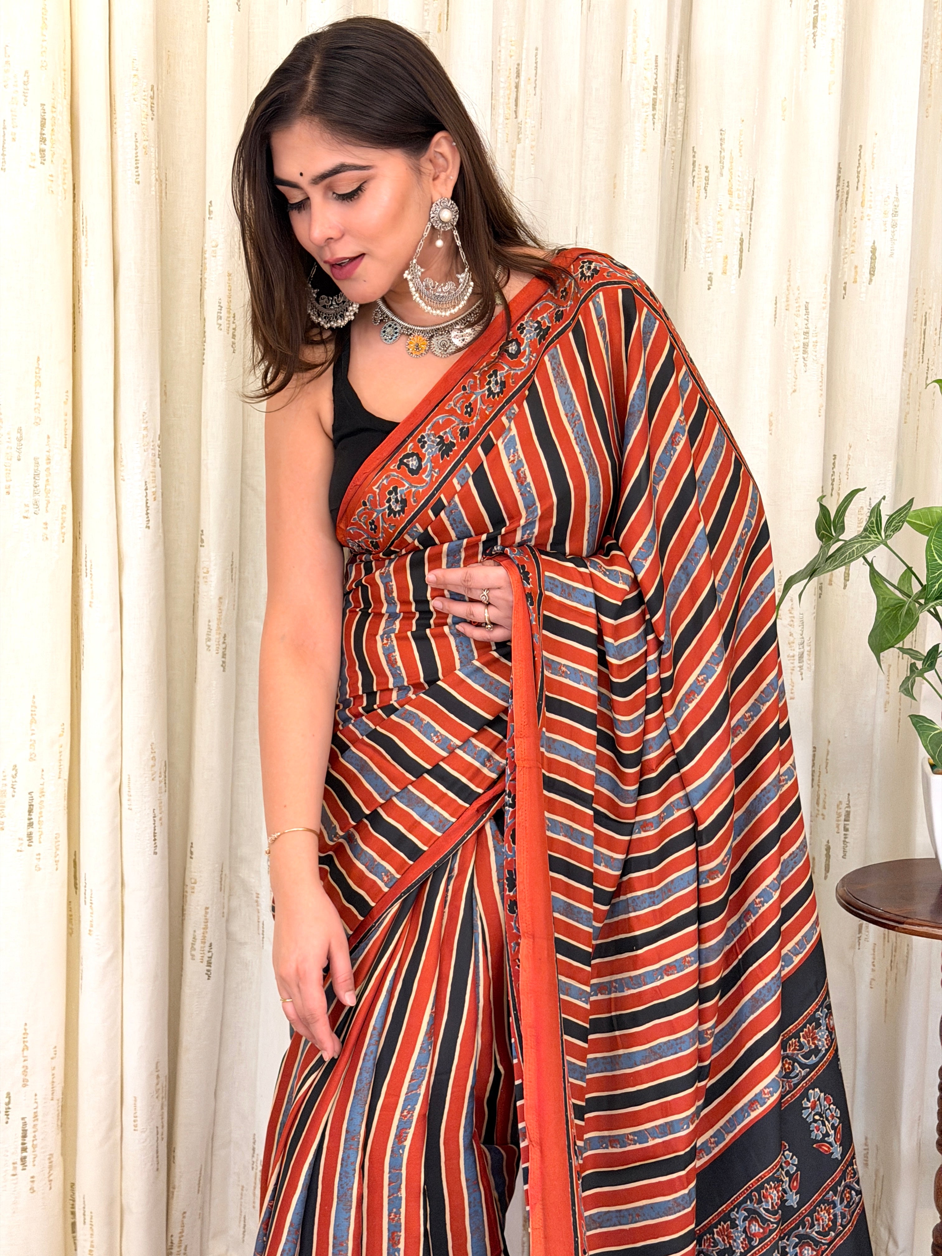 Close-up of rust black blue diagonal stripe saree with floral border detail