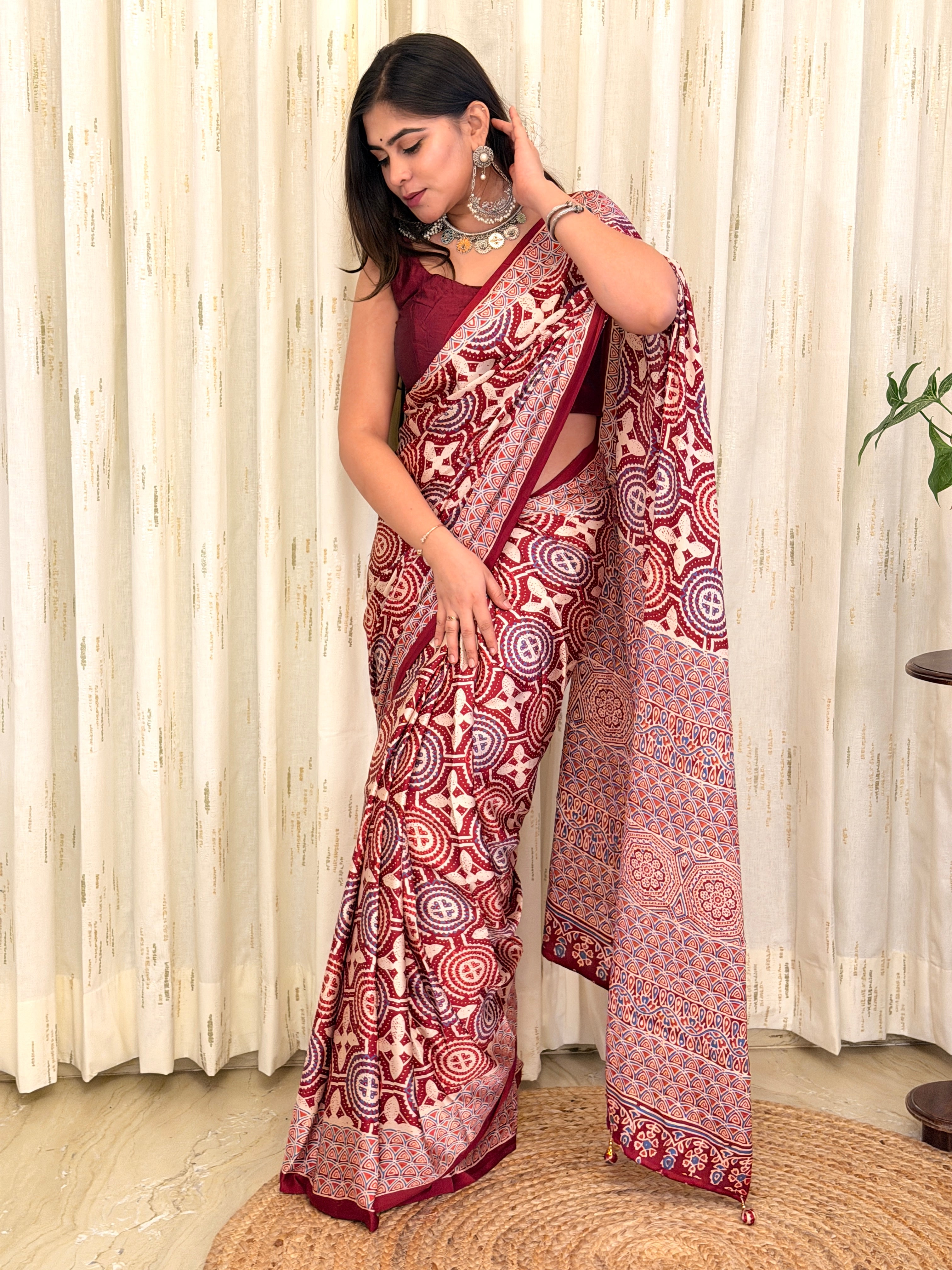 Draped maroon Ajrakh saree showing medallion and scallop pattern - side pose