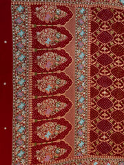 Close-up detail of a crimson red dupatta showing intricate gold zardozi, sequin, and pastel thread hand-embroidery forming large floral bouquets inside traditional architectural arches over a bandhani print.
