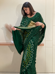 "Dark green Bandhani saree showcasing gold tissue pallu border by Pratibha Sarees."