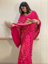 "Rani pink Bandhani saree showcasing gold tissue pallu border by Pratibha Sarees."