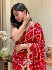 "Close-up of red Bandhani Garchola saree featuring an embroidered scalloped border by Pratibha Sarees."