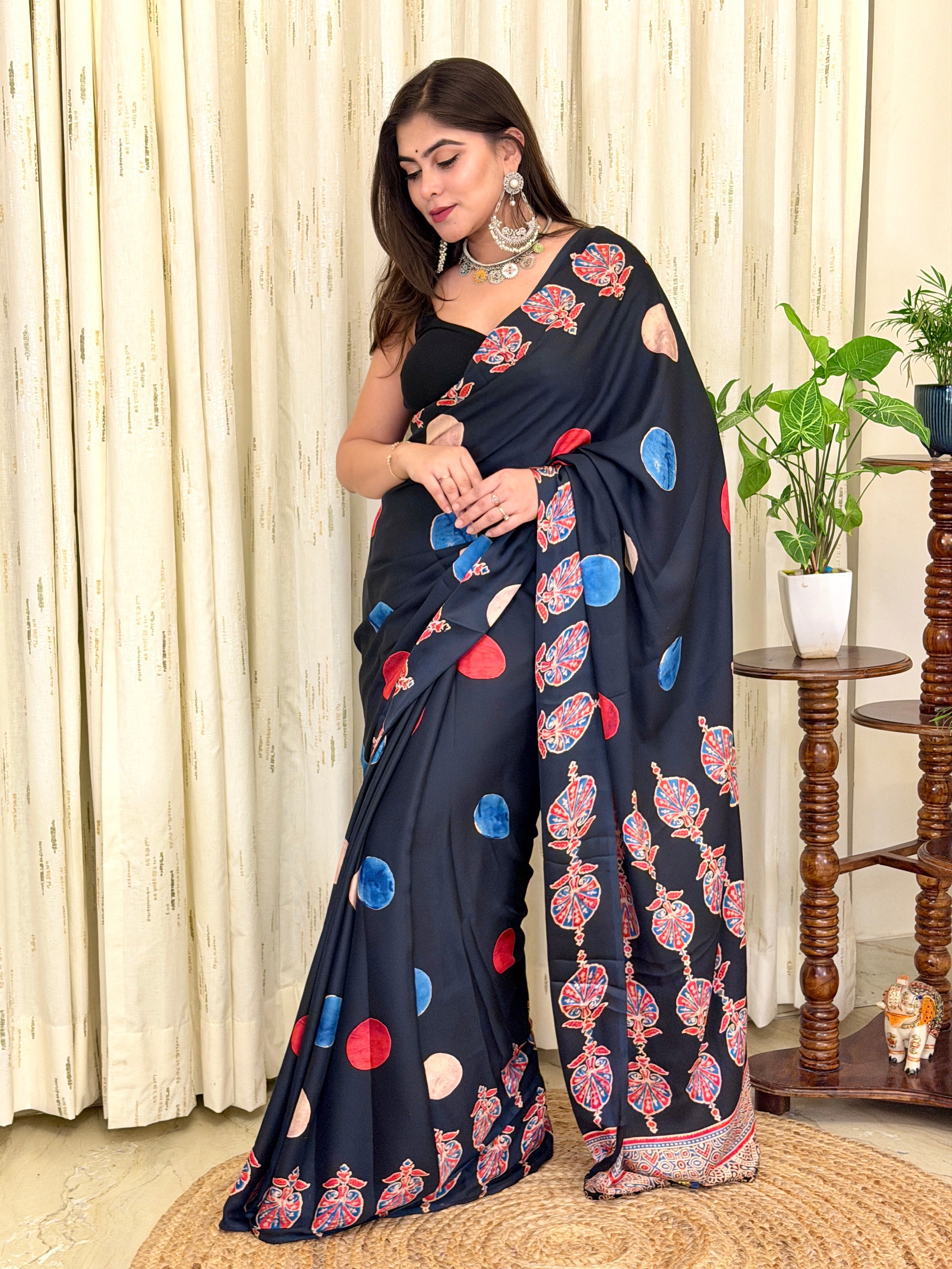 Side profile view of the elegant black printed crepe saree, highlighting the fluid drape and modern ethnic aesthetic perfect for festive wear.