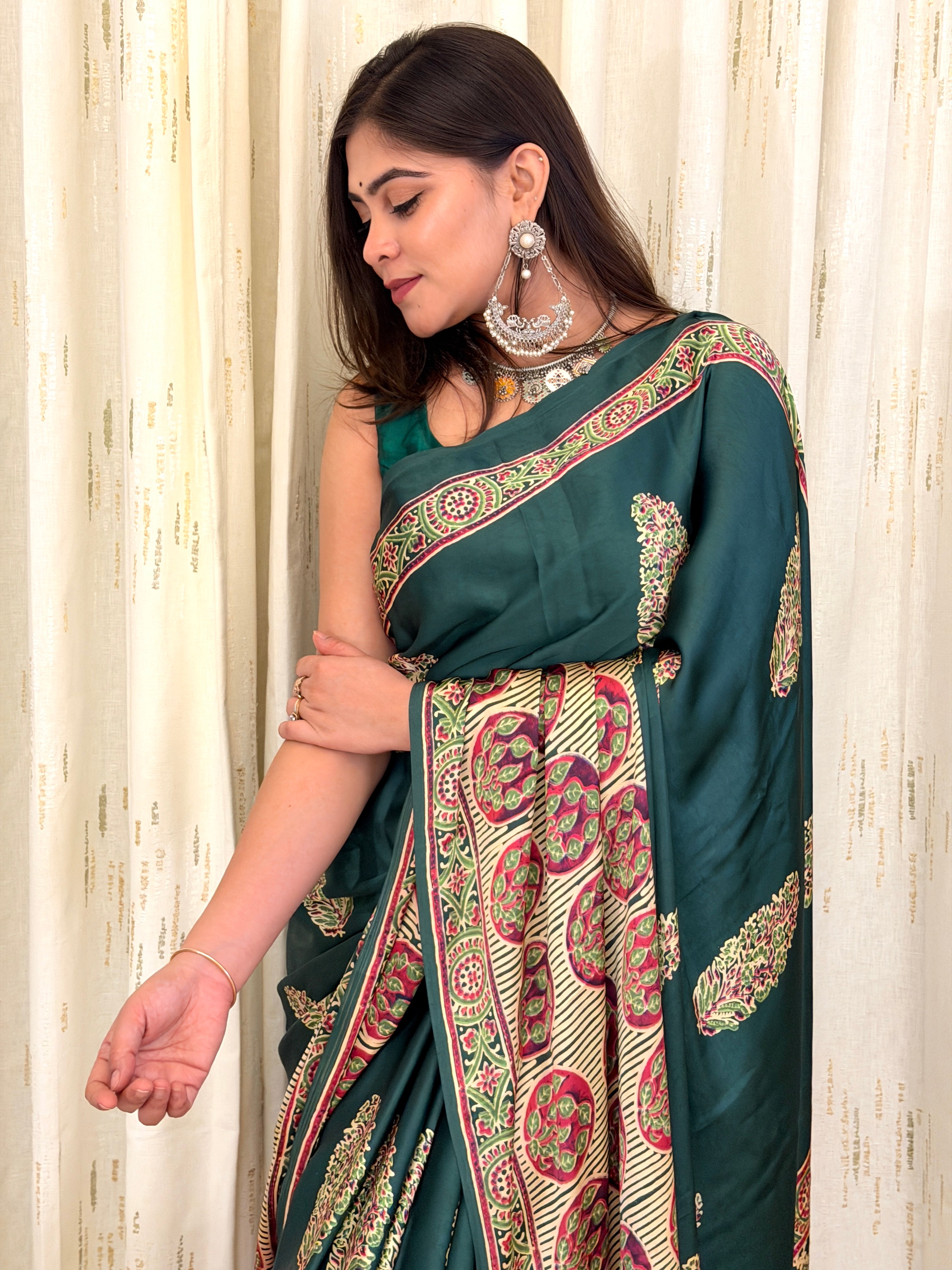 Close-up of green leaf booti print saree with Ajrakh border detail