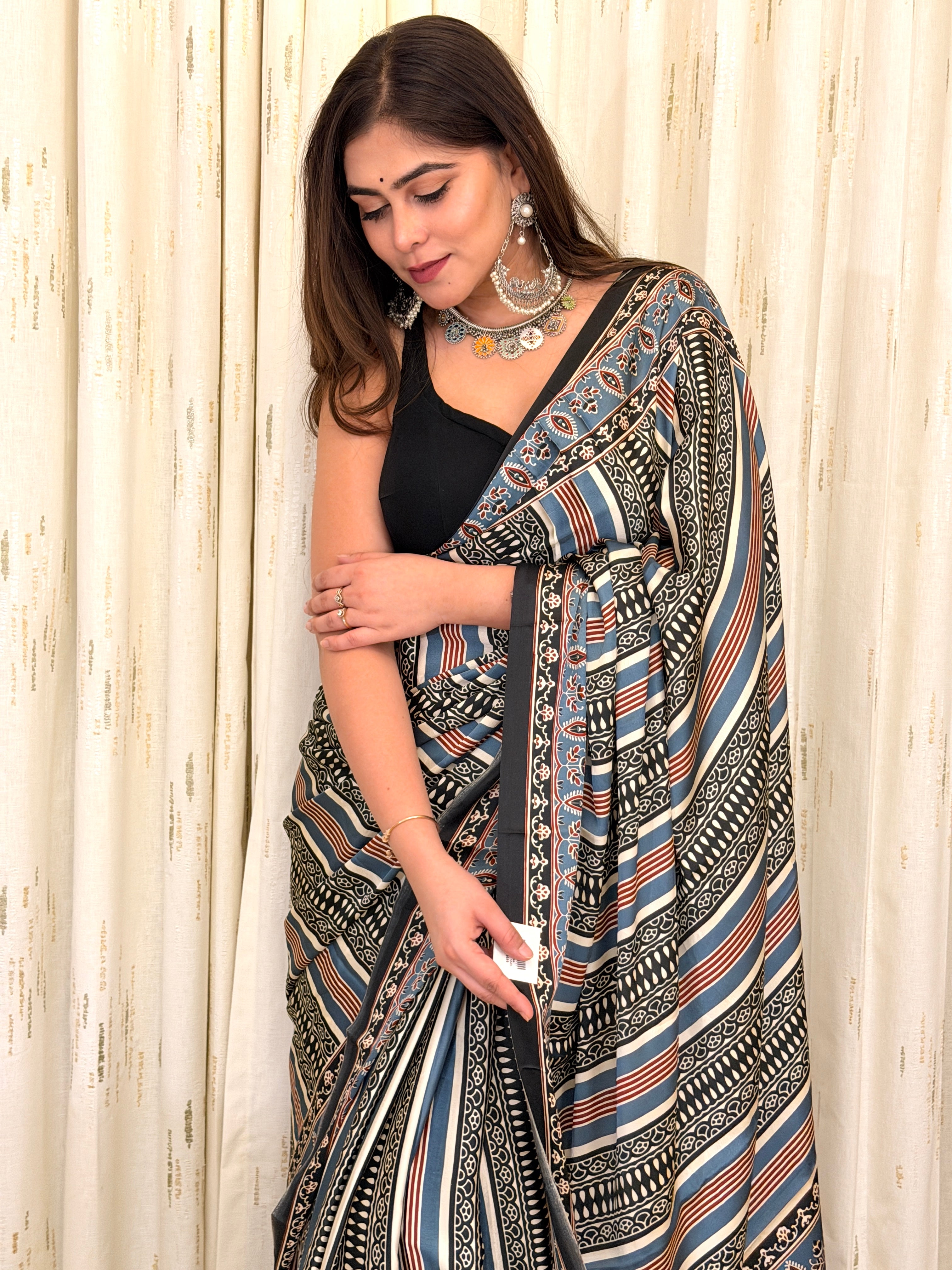Close-up of blue black rust diagonal stripe Ajrakh print saree fabric