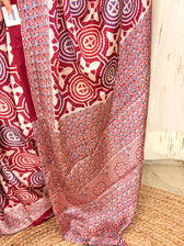 Close-up of maroon Ajrakh circular medallion and triangular scallop print fabric