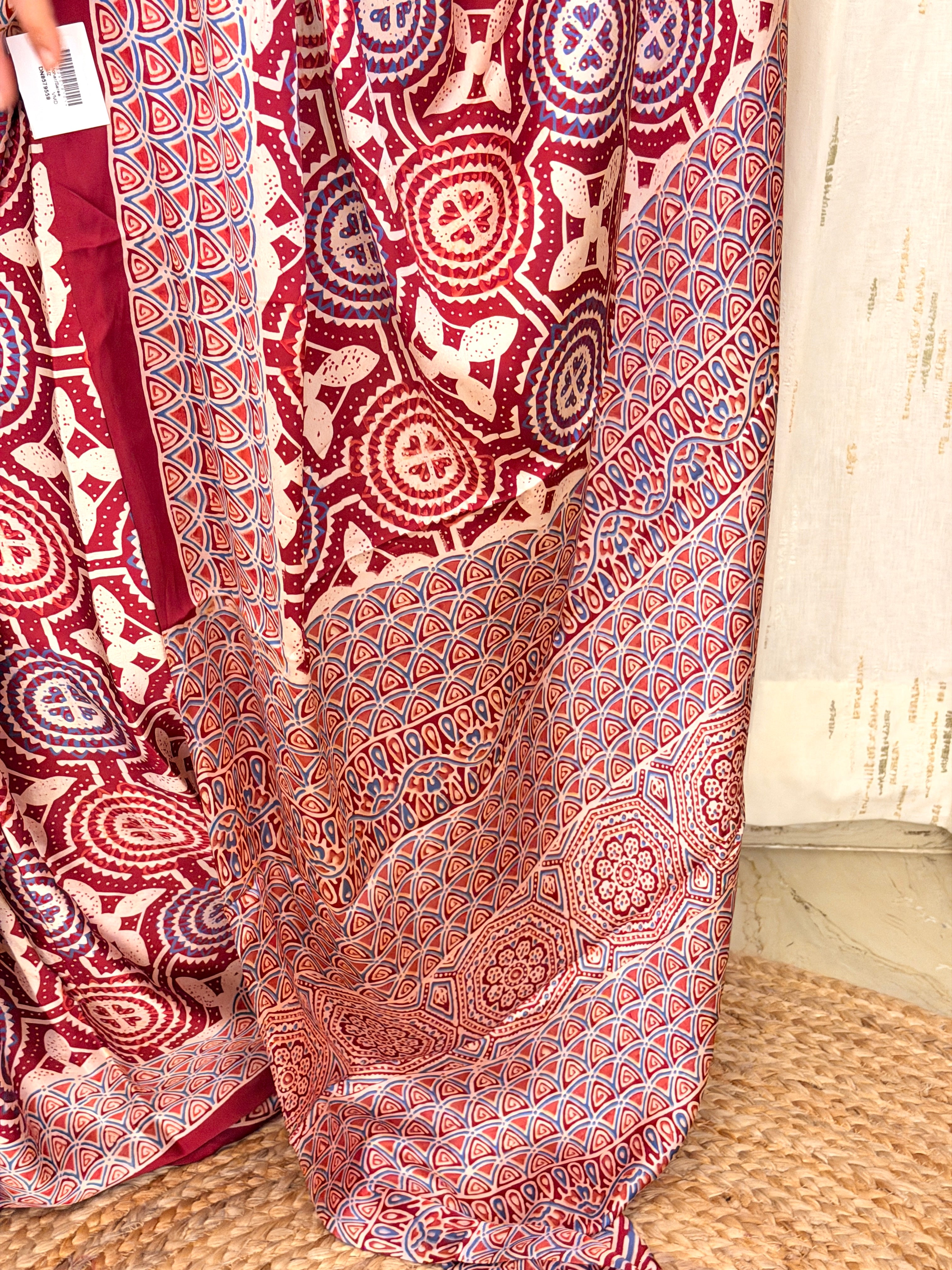 Close-up of maroon Ajrakh circular medallion and triangular scallop print fabric