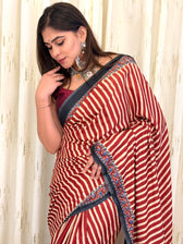 Woman in maroon striped saree with black border - side pose with jewellery