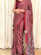 Close-up of maroon leaf-vine Ajrakh print saree fabric with border detail