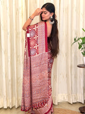 Woman in maroon Ajrakh medallion print saree - back view with open hair
