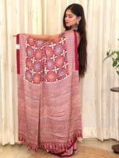Maroon Ajrakh geometric print modal silk saree pallu held open by model