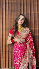 "Close-up detail of heavy gold embroidery on red Sonali Singh inspired Bandhani saree by Pratibha Sarees."